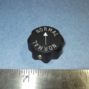 Knob, fluted, with arrow, marked NORMAL